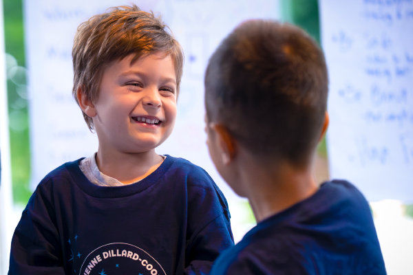 Two children playing, with colorful squirls surrounding them.